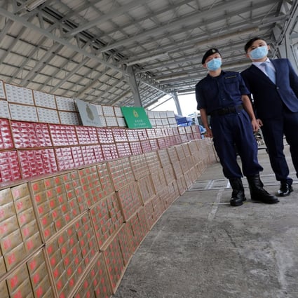 Customs officials present the latest haul of illegal cigarettes. Photo: Jelly Tse
