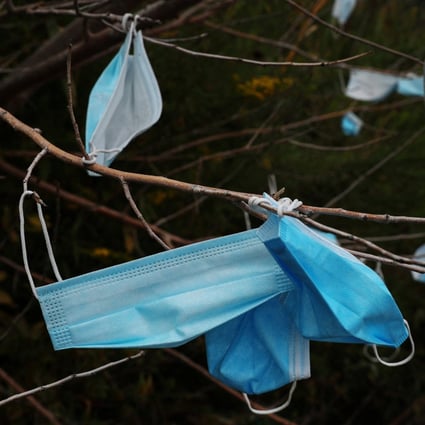 Face masks hang on trees on the entrance road to the Vernon C. Bain Correctional Detention Centre jail barge in New York on Monday. Photo: Reuters