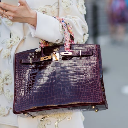 A woman wears a Hermès bag during Paris Fashion Week. The French luxury-goods company is set to increase its prices by between five per cent and 10 per cent in January. Photo: Getty Images