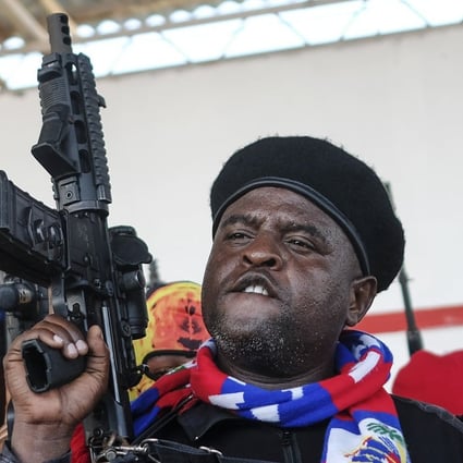 Gang leader Jimmy Cherizier, better known as Barbecue, shouts slogans with his gang members after giving a speech in Port-au-Prince, Haiti in October 2021. Photo: AP