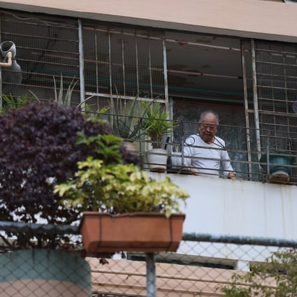 A man looks out from his balcony at Kwun Tong Garden Estate II in Ngau Tau Kok, which will be redeveloped in two phases, on April 11. Photo: Nora Tam