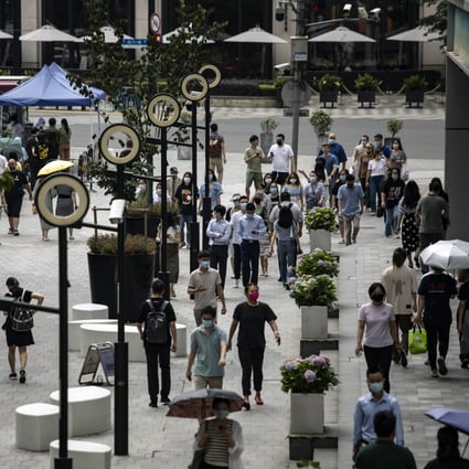 Pedestrians walked along a road in Shanghai on June 29, 2022 after the city’s authorities declared victory in their defence of the financial hub against Covid-19. Photo: Bloomberg.