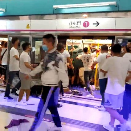 A mob of men in white T-shirts attacked black-clad protesters and passengers on a late night train after protesters were returning to the Yuen Long MTR Station. Photo: Handout