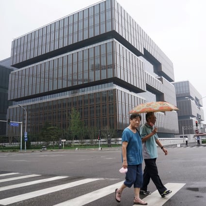People walk past the headquarters of Asian Infrastructure Investment Bank in Beijing. Photo: Reuters