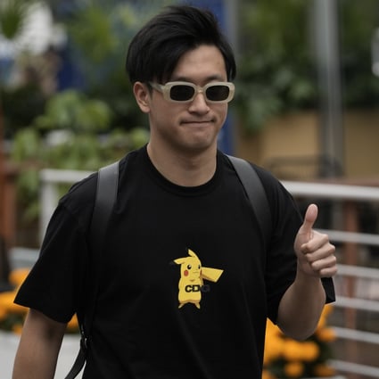 Zhou Guanyu gives a thumbs up upon his arrival for the first day of the Mexico Grand Prix. Photo: AP