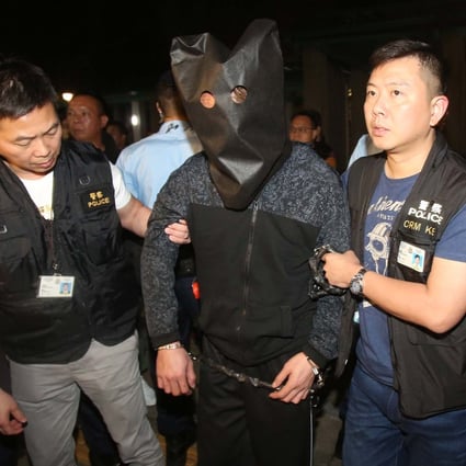 Police escorting the suspect in 2019 at Po Lam Estate. Photo: Handout