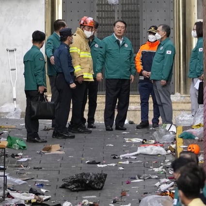 South Korean President Yoon Suk-yeol (centre) is briefed at the scene where dozens of people died and were injured in Seoul following a Halloween celebration. Photo: AP