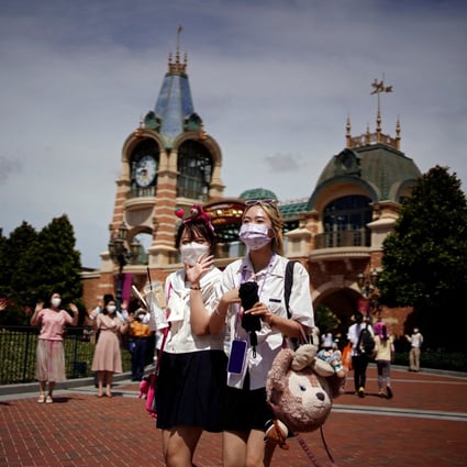 People wearing face masks visit the Shanghai Disney Resort as it reopens on June 30, 2022 following a long Covid-19 closure. Photo: Reuters