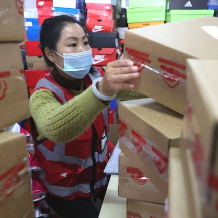An employee sorts packages for delivery ahead of the Singles’ Day shopping festival at Tianma E-commerce Industrial Park in Lianyungang, Jiangsu province on Tuesday. Photo: AFP