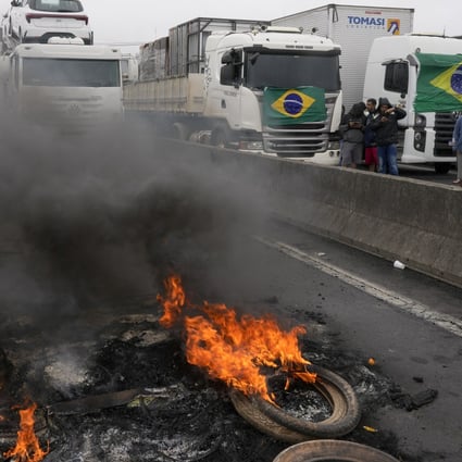 Truckers supportive of Brazilian President Jair Bolsonaro block a highway on Tuesday to protest against his election loss to former President Luiz Inácio Lula da Silva. Photo: AP