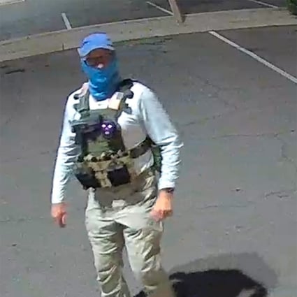 An armed individual dressed in tactical gear at a ballot drop box in Arizona, US, in October. Photo: TNS