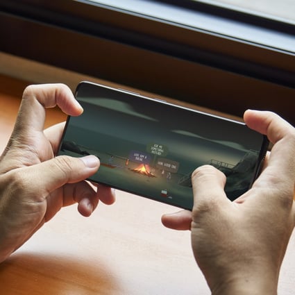 A user plays supernatural game Oxenfree on a mobile phone, one of 35 available through Netflix as it invests in the gaming market. The streaming giant has been buying up games studios and looking at cloud gaming options. Photo: Shutterstock