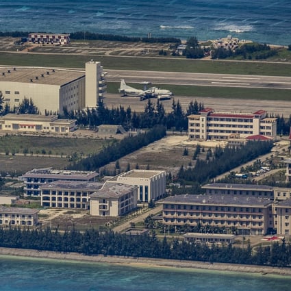 A plane sits on an airfield next to buildings and structures on the artificial island built by China at Fiery Cross Reef on October 25, 2022 in the Spratly Islands, South China Sea.  Photo: Ezra Acayan/Getty Images