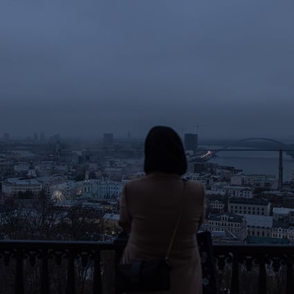 A woman looks out over Kyiv as blackouts continue. Photo: EPA-EFE