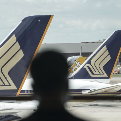 A man is seen silhouetted against Singapore Airlines aeroplanes at Changi Airport in Singapore. Photo: EPA-EFE