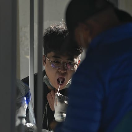 Residents line up to get their routine Covid-19 throat swabs in Beijing. China’s zero-Covid strategy has kept the death toll low. Photo: AP