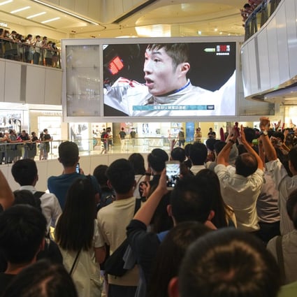 Hong Kong mall-goers cheer as local fencing hero Edgar Cheung wins gold at the 2020 Olympics. Photo: Winson Wong