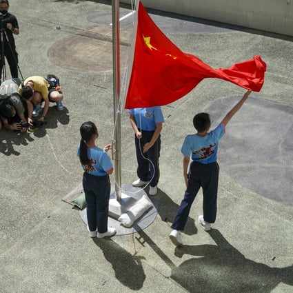 Pupils perform a flag-raising ceremony. Photo: Felix Wong