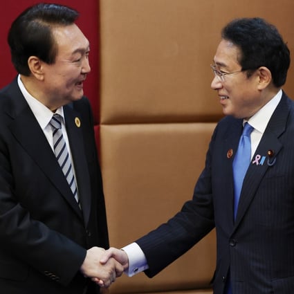 South Korean President Yoon Suk-yeol (left) and Japanese Prime Minister Fumio Kishida pose for a photo during their bilateral meeting during the Asean Summit in Phnom Penh in Cambodia on Sunday. Photo: EPA-EFE/Yonhap