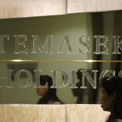 An employee walks past a Temasek Holdings sign at the company’s headquarters in Singapore. Photo: Reuters