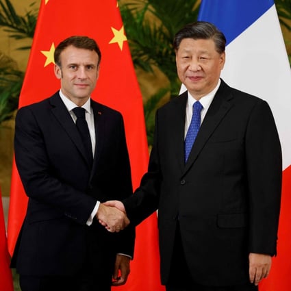 French President Emmanuel Macron shakes hands with his Chinese counterpart Xi Jinping ahead of their meeting in Bali on Tuesday. Photo: AFP