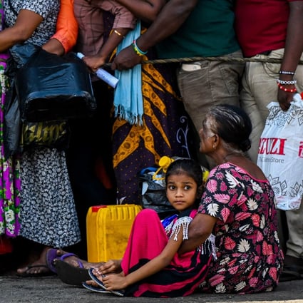 People queue to buy kerosene for domestic use in Colombo, Sri Lanka, in May. File photo: AFP