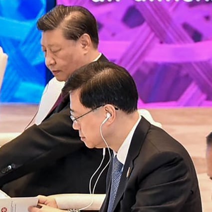 John Lee Ka-chiu is seen seated between Chinese President Xi Jinping and Indonesian President Joko Widodo during closed-door sessions of the Apec summit on Friday. Photo: APEC twitter