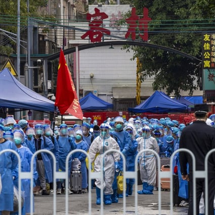 Residents in blue PPE prepare to be transferred from an urban village in Guangzhou, in southern China’s Guangdong province, to a Covid-19 quarantine centre. Photo: AP