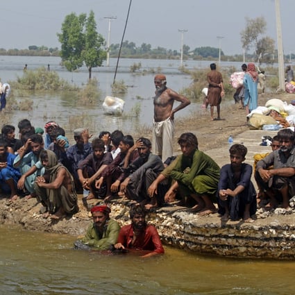 Victims of heavy flooding from monsoon rains wait to receive relief aid from the Pakistani Army in Sindh Province, Pakistan, in September. Photo: AP