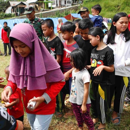 Children queuing for milk during trauma healing treatment at a relief centre after the earthquake. Photo: Reuters