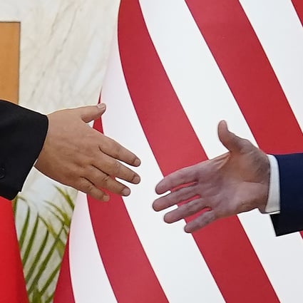 US President Joe Biden and Chinese President Xi Jinping reach out to shake hands before their meeting on the sidelines of the G20 summit on November 14 in Nusa Dua, Bali, Indonesia. Photo: AP