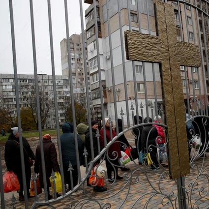 People queue to get food, water and aid at the Church of Christ the Saviour in Kherson, Ukraine on Monday. Photo: Reuters 