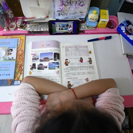 A student reads a math textbook written in Chinese. Tencent and Alibaba’s AI models have scored better than humans on a set of language processing tasks. Photo: Xinhua