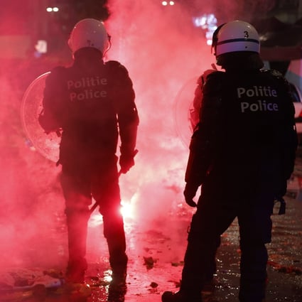 Riot police deploy during clashes with Moroccan football fans in the streets of Brussels, Belgium on Sunday. Photo: EPA-EFE