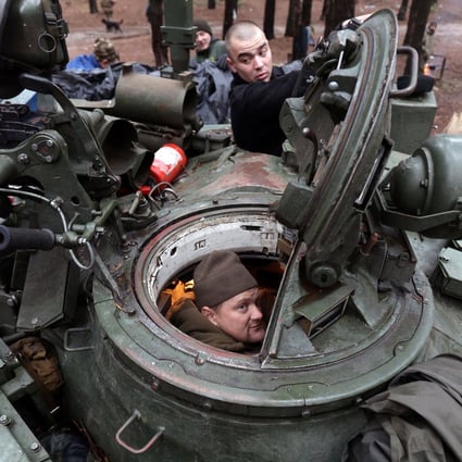 Ukrainian servicemen repair a captured Russian tank in a forest near the front line in the Kharkiv region. Photo: AFP