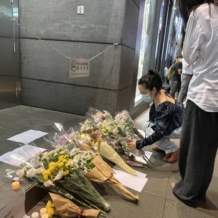 People lay flowers at a vigil in Hong Kong to commemorate a deadly fire in Xinjiang that sparked an outcry in mainland China over Covid-19 lockdown rules. Photo: Oscar Liu