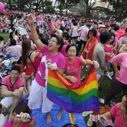 People wave a rainbow flag at the Pink Dot pride rally in Singapore in June 2013. File photo: AP 