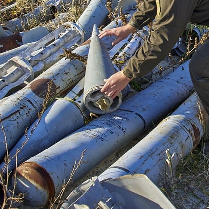 A worker for the prosecutor’s office looks at used missiles collected to be presented as evidence of Russian shellings against civilian targets in Kharkiv on Tuesday. Photo: EPA-EFE