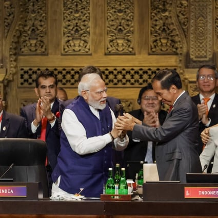 India’s Prime Minister Narendra Modi takes the gavel from Indonesia’s President Joko Widodo in a handover ceremony during the G20 summit. Photo: EPA-EFE
