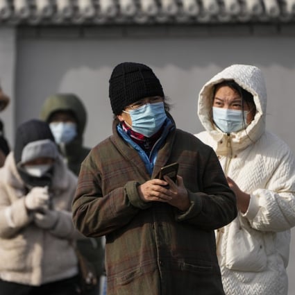 Residents stand in line for their routine COVID-19 tests in freezing cold weather in Beijing on November 29. Chinese universities are sending students home as the Communist Party tries to prevent more zero-Covid protests. Photo: AP 