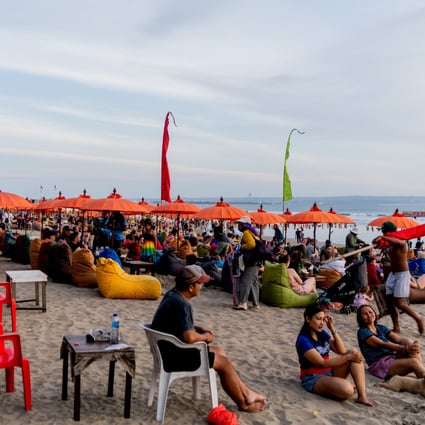 People hang out at Seminyak Beach, Bali, in the evening. Tourism on the Indonesian island is picking up again as the Covid-19 pandemic eases. Photo: Getty Images