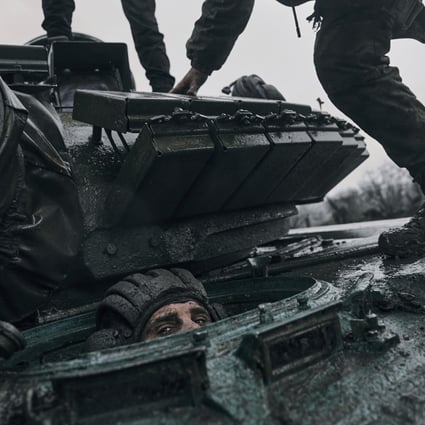 A Ukrainian soldier peers out of a captured Russian tank at the front line in the Donetsk region, Ukraine. Photo: AP