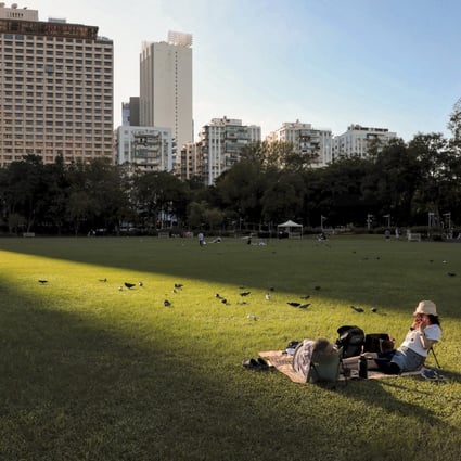 Residents enjoy the sunshine while sitting in Victoria Park in November. Photo: Elson Li