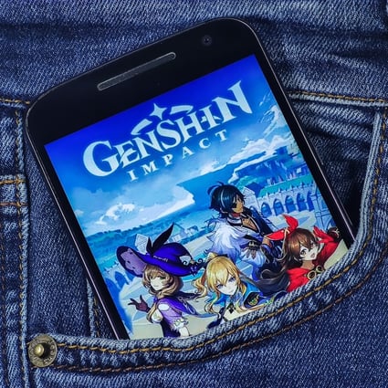 In this photo illustration taken March 26, 2021, a Genshin Impact logo is seen displayed on a smartphone. Photo: Shutterstock Images