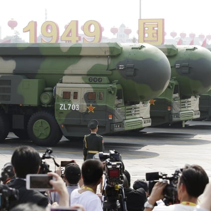 Military vehicles carrying intercontinental ballistic missiles drive past Tiananmen Square in Beijing during a celebratory parade. Photo: Reuters