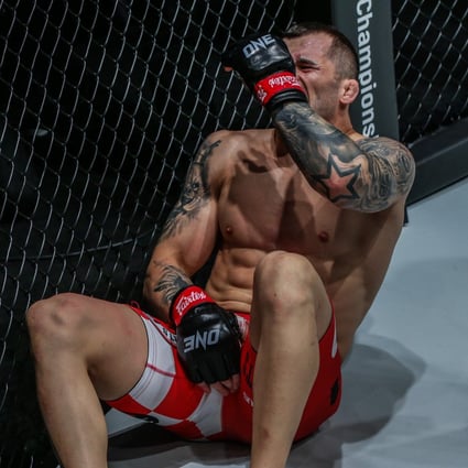 Roberto Soldic writhes in pain after absorbing a low-blow in his ONE Championship debut. Photo: ONE Championship. 