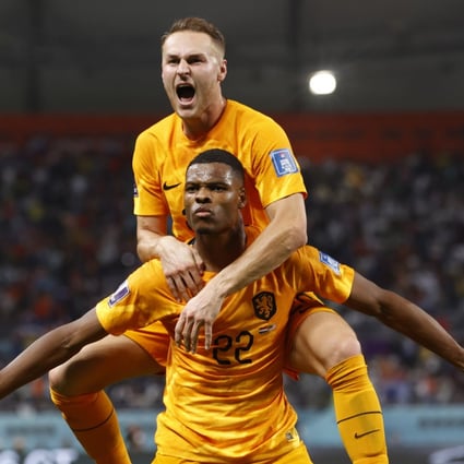 Denzel Dumfries of the Netherlands celebrates with teammate Teun Koopmeiners, top, at the Fifa World Cup match against the US in Doha, Qatar on Saturday. Photo: EPA-EFE