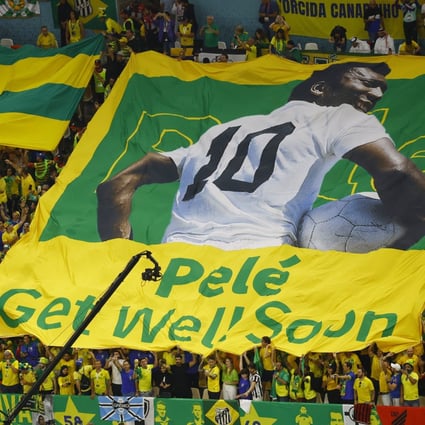 Brazil fans display a banner with an image of former football player Pele before their match on Friday. Photo: Reuters 