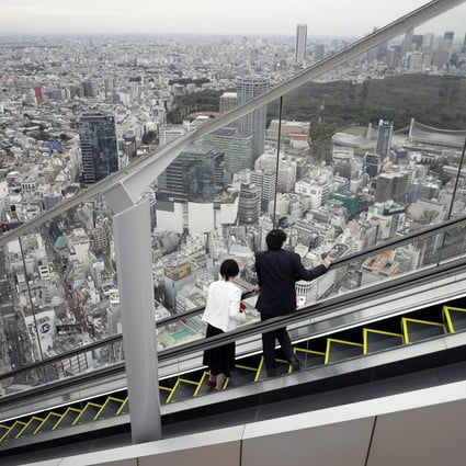 Visitors look out at the view while riding an escalator at Shibuya Sky, the observation deck at the rooftop of Shibuya Scramble Square in Tokyo, in 2020. Photo: Bloomberg 