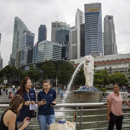 People visit Merlion Park in Singapore last week. The city state no longer mandates mask wearing outside or in most indoor settings. Photo: EPA-EFE